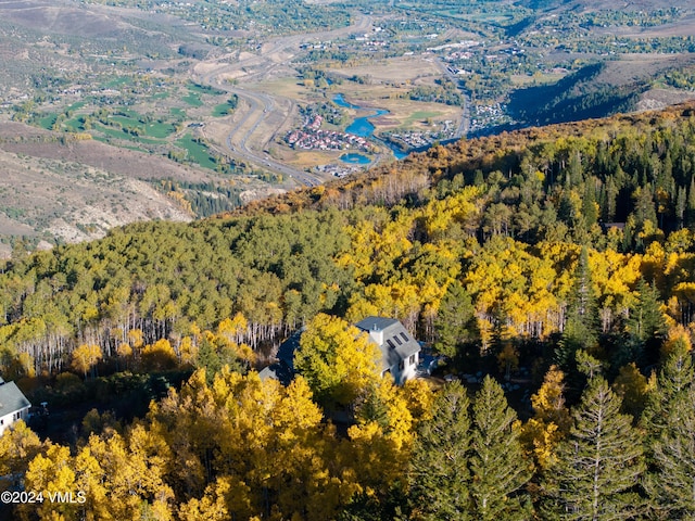 birds eye view of property featuring a view of trees