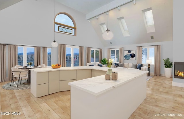 kitchen with light wood-style flooring, a skylight, open floor plan, and a kitchen island