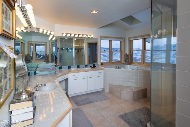 bathroom with a sink, a shower stall, a bath, and tile patterned floors