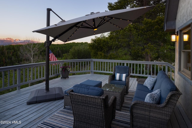 deck at dusk with outdoor lounge area