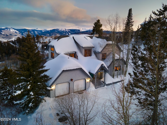 snowy aerial view featuring a mountain view