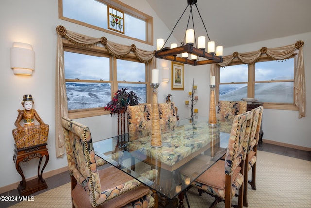 dining space featuring tile patterned floors, baseboards, lofted ceiling, and a notable chandelier