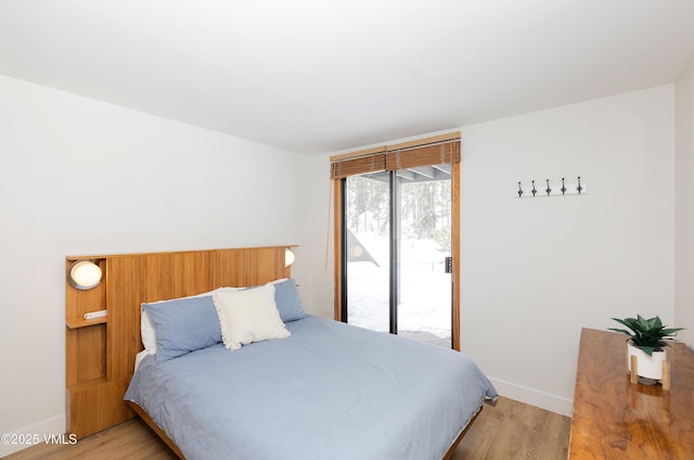 1610 Buffehr Creek Rd Unit A-22, Vail, CO 81657 - bedroom with access to outside and light wood-style flooring