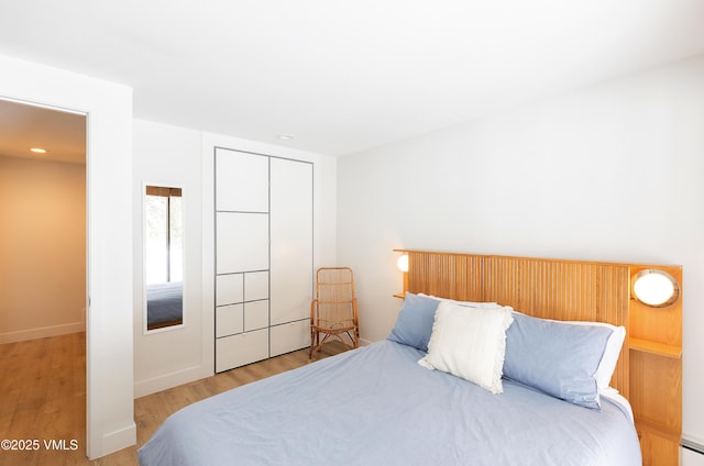 1610 Buffehr Creek Rd Unit A-22, Vail, CO 81657 - bedroom featuring wood finished floors, a baseboard radiator, and recessed lighting