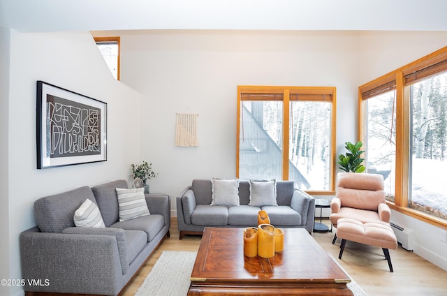 1610 Buffehr Creek Rd Unit A-22, Vail, CO 81657 - living area with light wood-type flooring and a baseboard heating unit
