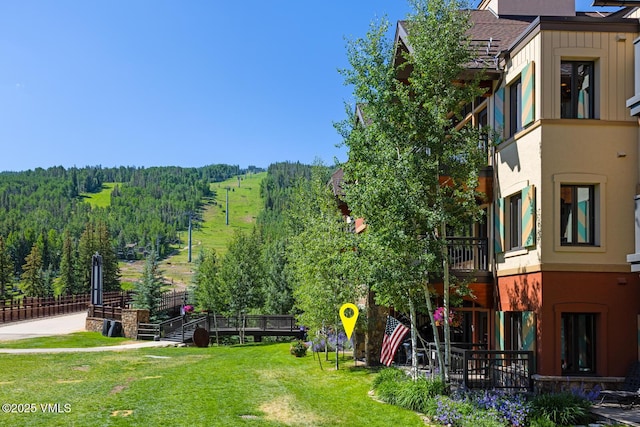 660 Lionshead Pl Unit 29, Vail, CO 81658 - view of green lawn with a wooded view
