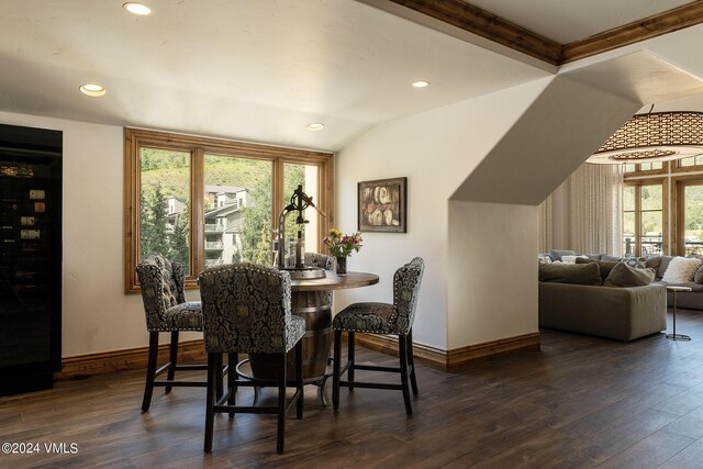 dining room featuring lofted ceiling and dark wood-type flooring