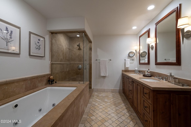 bathroom with shower with separate bathtub, vanity, and tile patterned floors