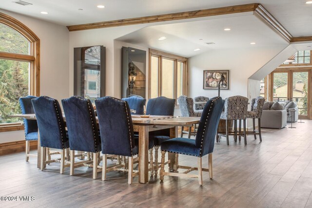 dining room with lofted ceiling, a wealth of natural light, and wood-type flooring