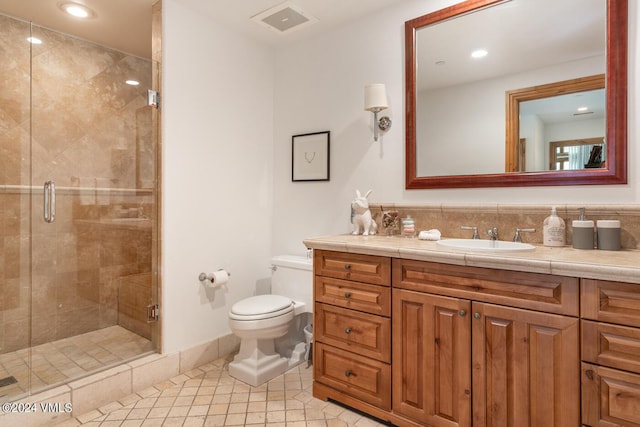 bathroom with walk in shower, vanity, toilet, and tile patterned flooring