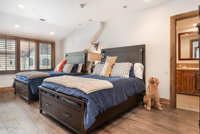 bedroom featuring lofted ceiling and wood-type flooring