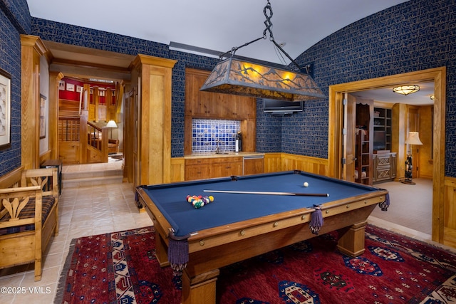 recreation room featuring wallpapered walls, pool table, wainscoting, light tile patterned floors, and vaulted ceiling