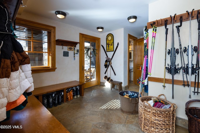 interior space with baseboards and stone finish flooring