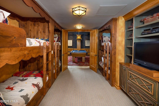 interior space featuring light carpet and wooden walls