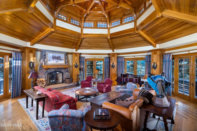 living area with a fireplace, wood ceiling, french doors, and beamed ceiling