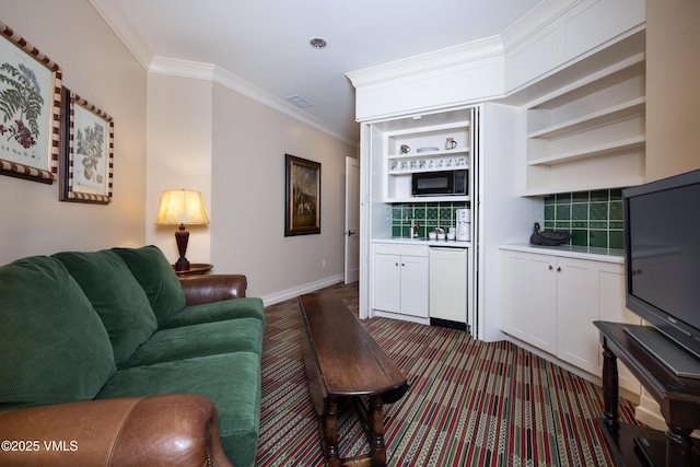 living room with visible vents, baseboards, and ornamental molding