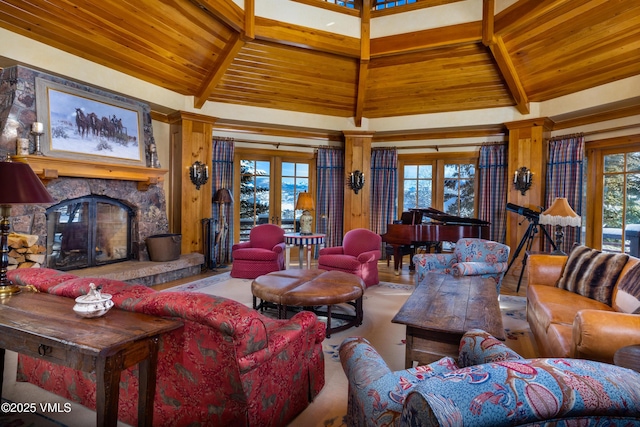 living area with wooden ceiling, lofted ceiling with beams, a fireplace, and french doors