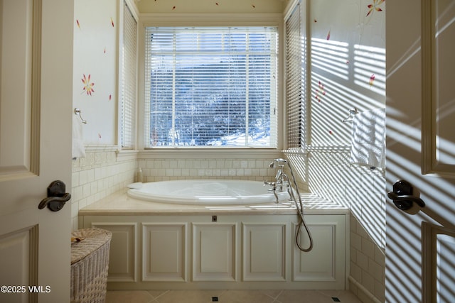 full bath featuring tile walls, a bath, and tile patterned flooring