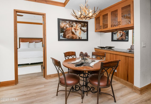120 Offerson Rd Unit D330, Beaver Creek, CO 81620 - dining space featuring a chandelier, light wood finished floors, and baseboards