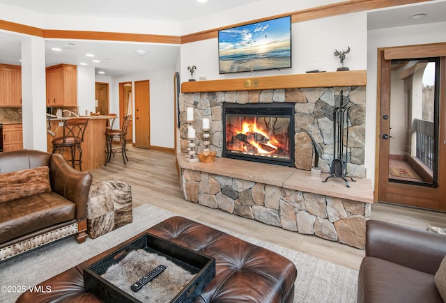 120 Offerson Rd Unit D330, Beaver Creek, CO 81620 - living room with a stone fireplace, light wood-style floors, recessed lighting, and baseboards