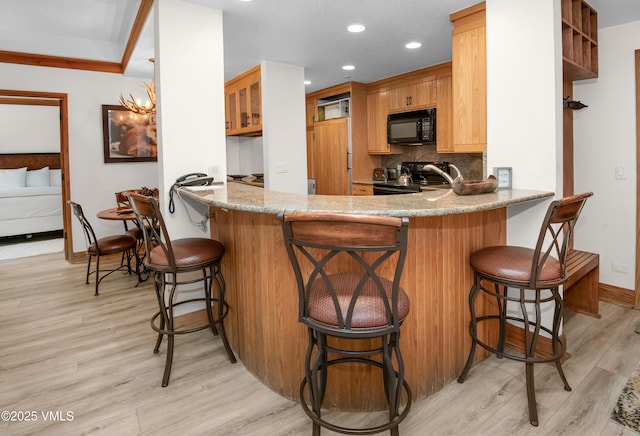 120 Offerson Rd Unit D330, Beaver Creek, CO 81620 - kitchen featuring black microwave, electric range, light wood-type flooring, decorative backsplash, and recessed lighting