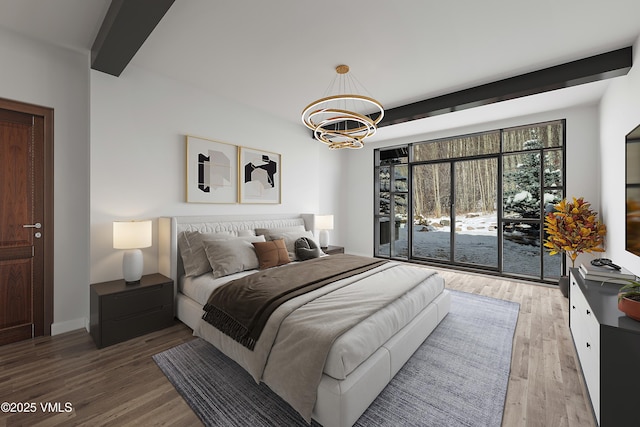 1094 Riva Gln, Vail, CO 81657 - bedroom with a chandelier, beam ceiling, and wood finished floors