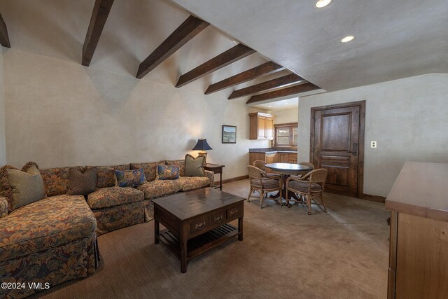 carpeted living area with recessed lighting, beamed ceiling, and baseboards