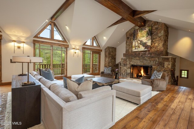 1094 Riva Gln, Vail, CO 81657 - living area featuring a stone fireplace, hardwood / wood-style flooring, beam ceiling, high vaulted ceiling, and recessed lighting