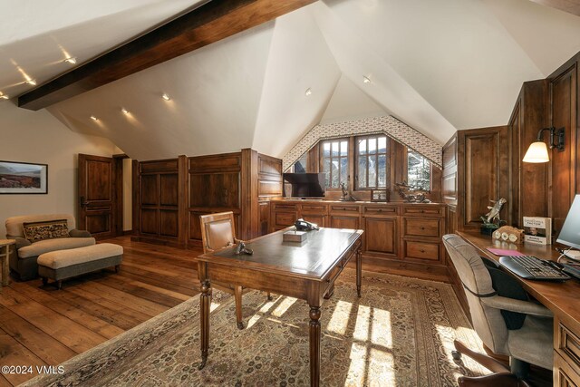 home office featuring wooden walls, lofted ceiling with beams, and wood finished floors