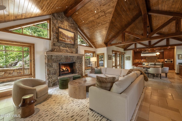 1094 Riva Gln, Vail, CO 81657 - living room with a stone fireplace, high vaulted ceiling, a wood ceiling with exposed beams, and stone tile flooring