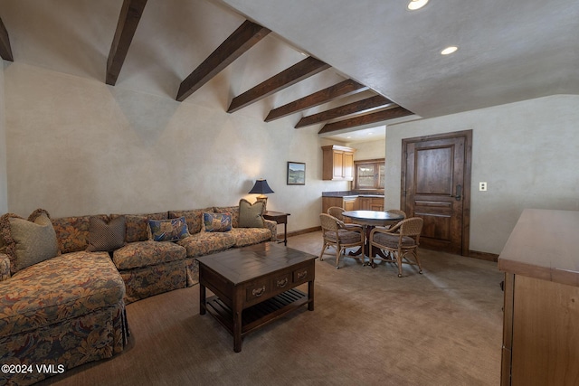 living room featuring beam ceiling, baseboards, and carpet flooring