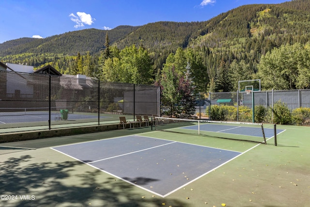 view of tennis court with a mountain view