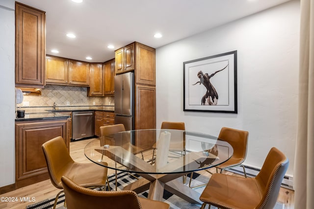 dining space with light hardwood / wood-style floors