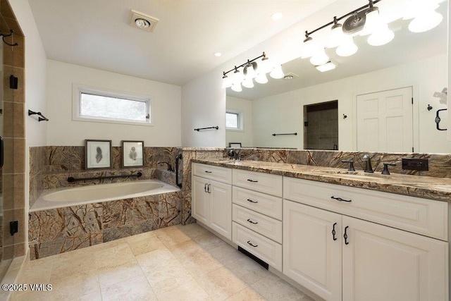 170 Wildflower Unit 12, Edwards, CO 81632 - bathroom with double vanity, a garden tub, a tile shower, tile patterned floors, and recessed lighting