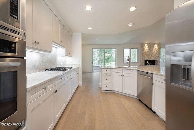 170 Wildflower Unit 12, Edwards, CO 81632 - kitchen with stainless steel appliances, light wood-style flooring, recessed lighting, and backsplash