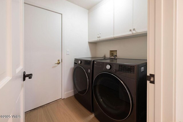 170 Wildflower Unit 12, Edwards, CO 81632 - laundry room with cabinet space, washing machine and dryer, and light wood-style flooring