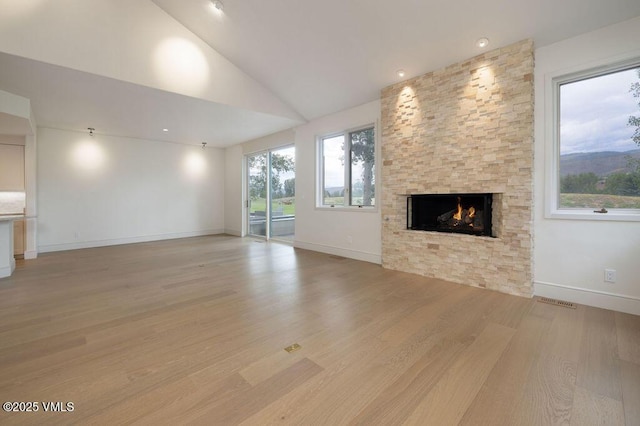 170 Wildflower Unit 12, Edwards, CO 81632 - unfurnished living room with light wood-style flooring, a fireplace, and lofted ceiling