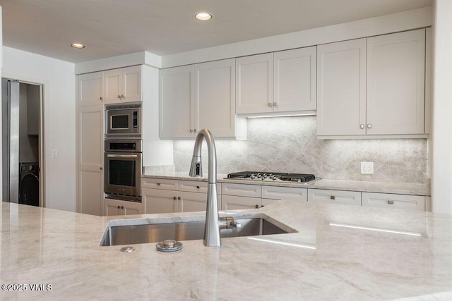 170 Wildflower Unit 12, Edwards, CO 81632 - kitchen featuring stainless steel appliances, light stone counters, decorative backsplash, and recessed lighting