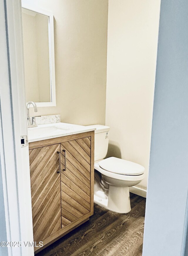804 Chickadee Ln, Gypsum, CO 81637 - half bath with toilet, vanity, and wood finished floors