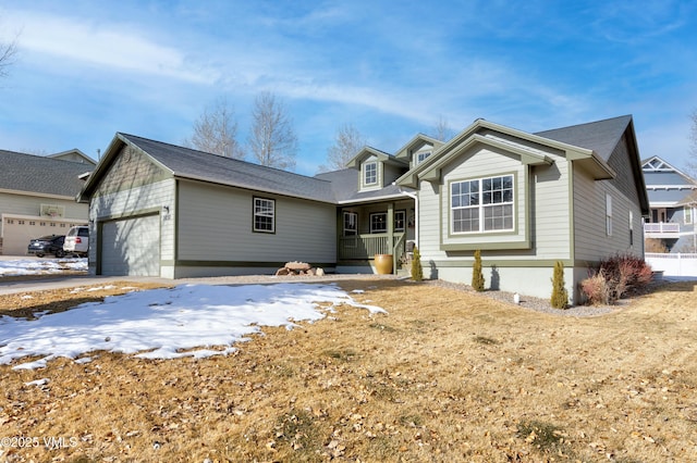 view of front of home featuring a porch and a garage