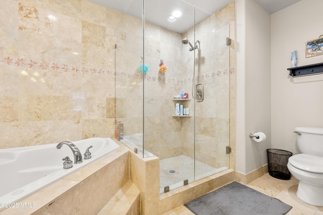 bathroom with tile patterned floors, toilet, and separate shower and tub