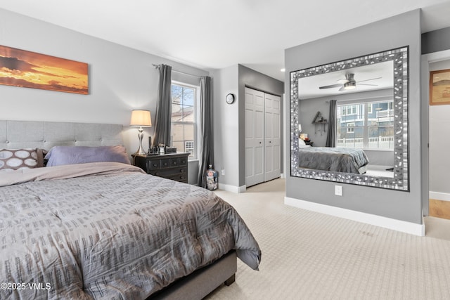 carpeted bedroom featuring multiple windows and a closet