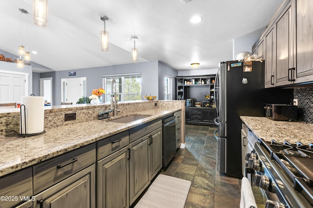 kitchen featuring dishwasher, stove, sink, and decorative light fixtures