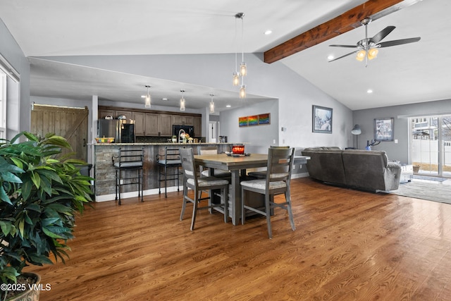 dining space featuring vaulted ceiling with beams, dark hardwood / wood-style floors, and ceiling fan