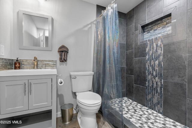 bathroom featuring a shower with curtain, vanity, and toilet