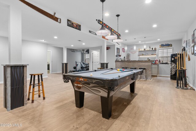 playroom featuring pool table, bar, and light wood-type flooring