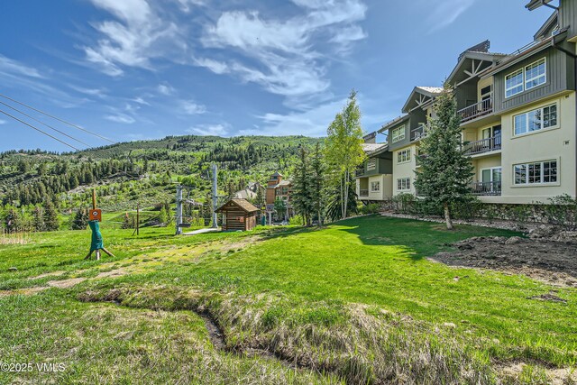 1120 Village Rd Unit 306, Beaver Creek, CO 81620 - view of green lawn with a forest view