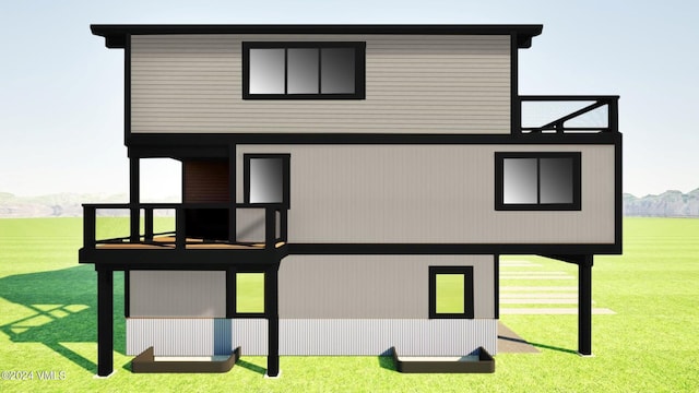 rear view of house featuring a mountain view and a lawn