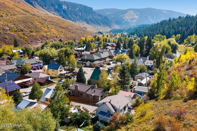 aerial view featuring a residential view, a view of trees, and a mountain view