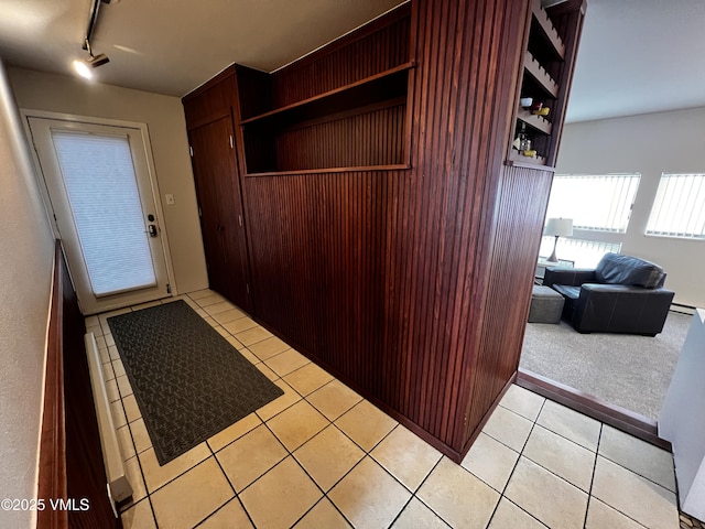 interior space featuring rail lighting and light tile patterned flooring